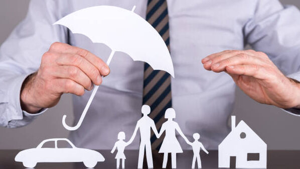 Man holding an umbrella protecting a family, a house and a car